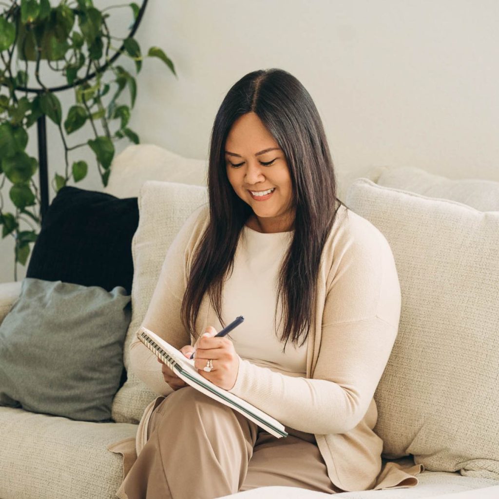 lizlyn lucrida writing on notebook