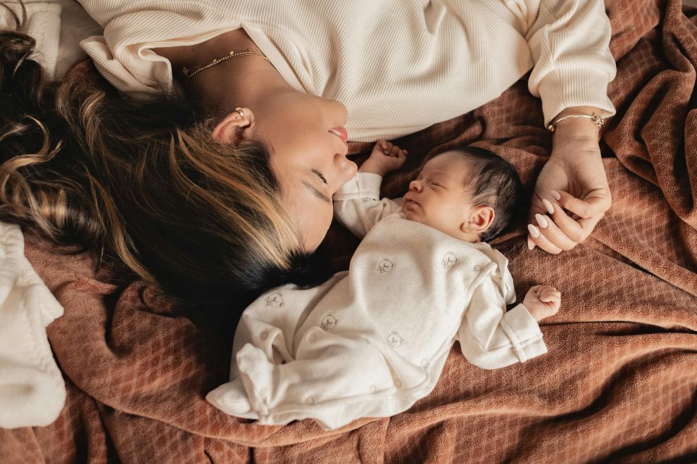 baby and mom sleeping in bed